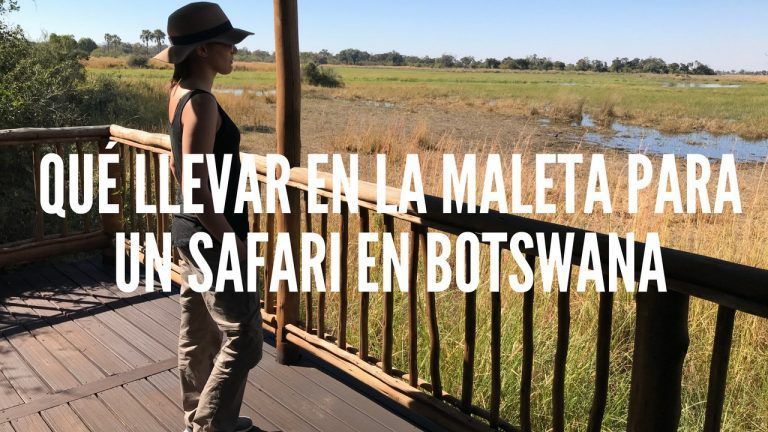 portada con el texto qué llevar en la maleta para un safari. Salgo yo de lado, mirando al paisaje desde la tienda con pantalón marrón camiseta negra de tirantes y sombrero marrón de safari.